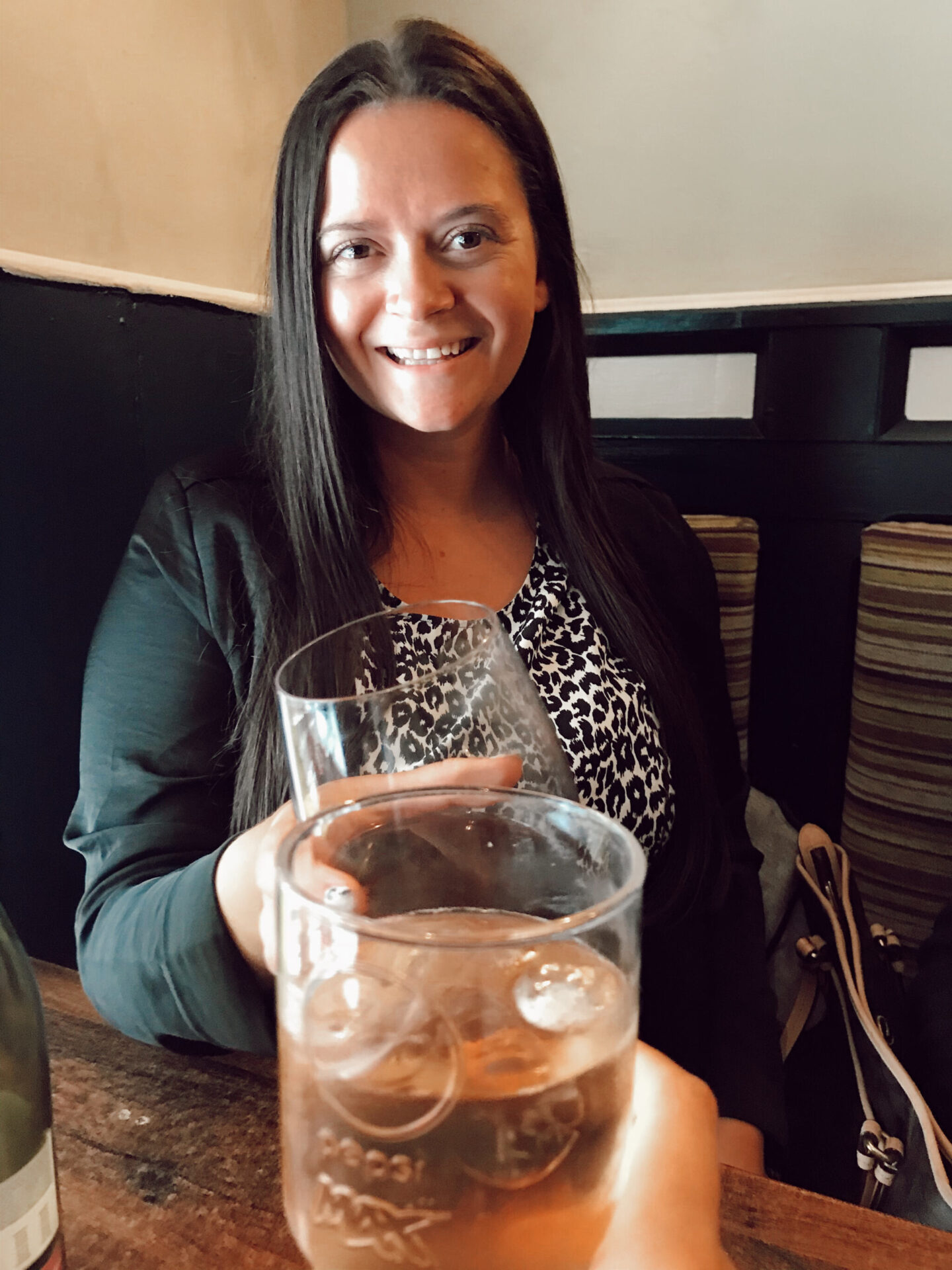 a woman does a cheers to the camera