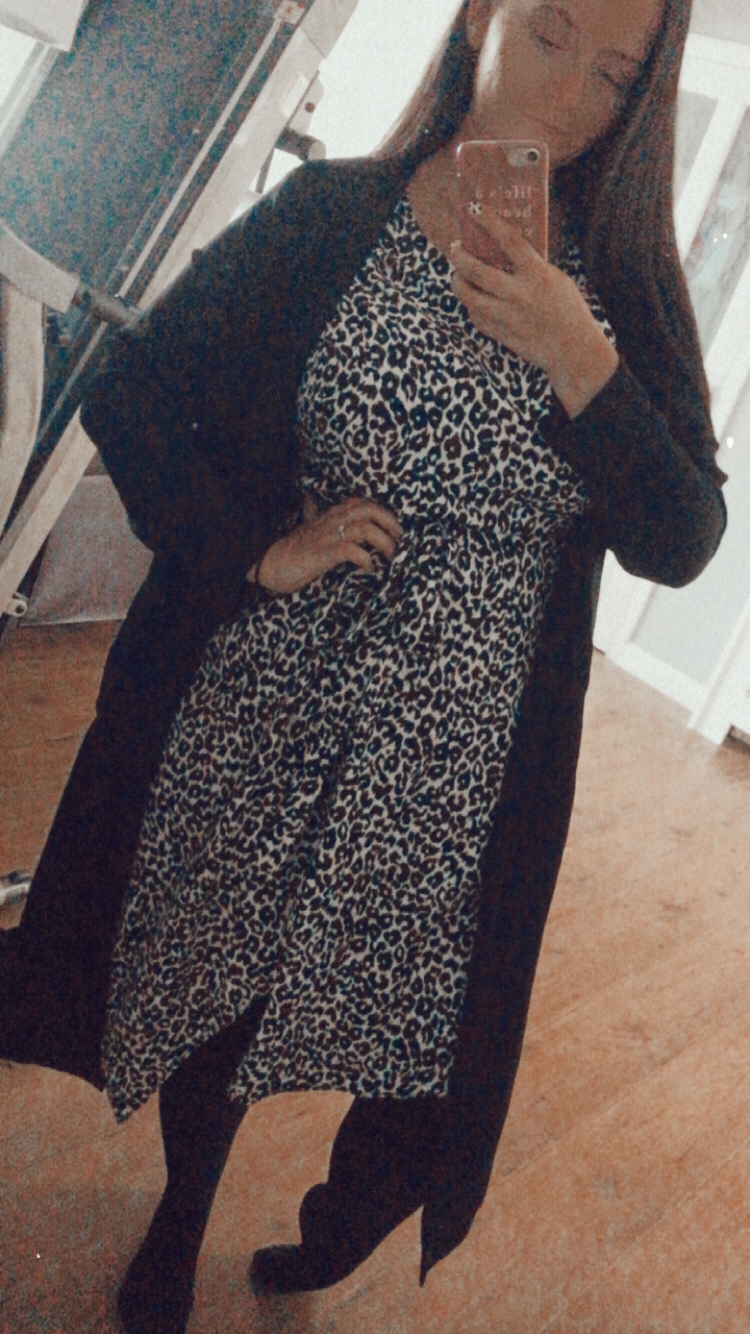 a woman poses in a monochrome outfit