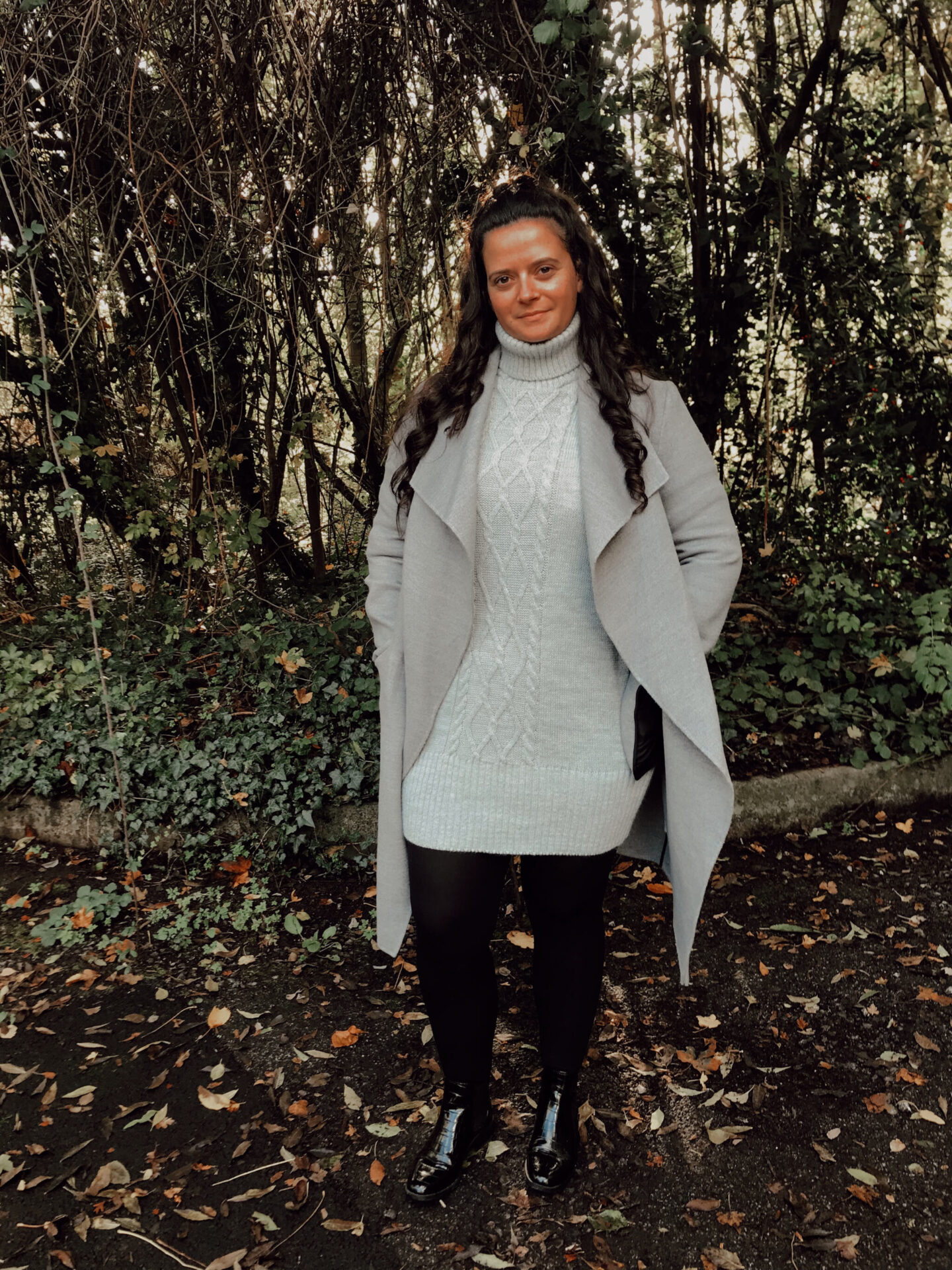 woman stands in Autumnal backdrop