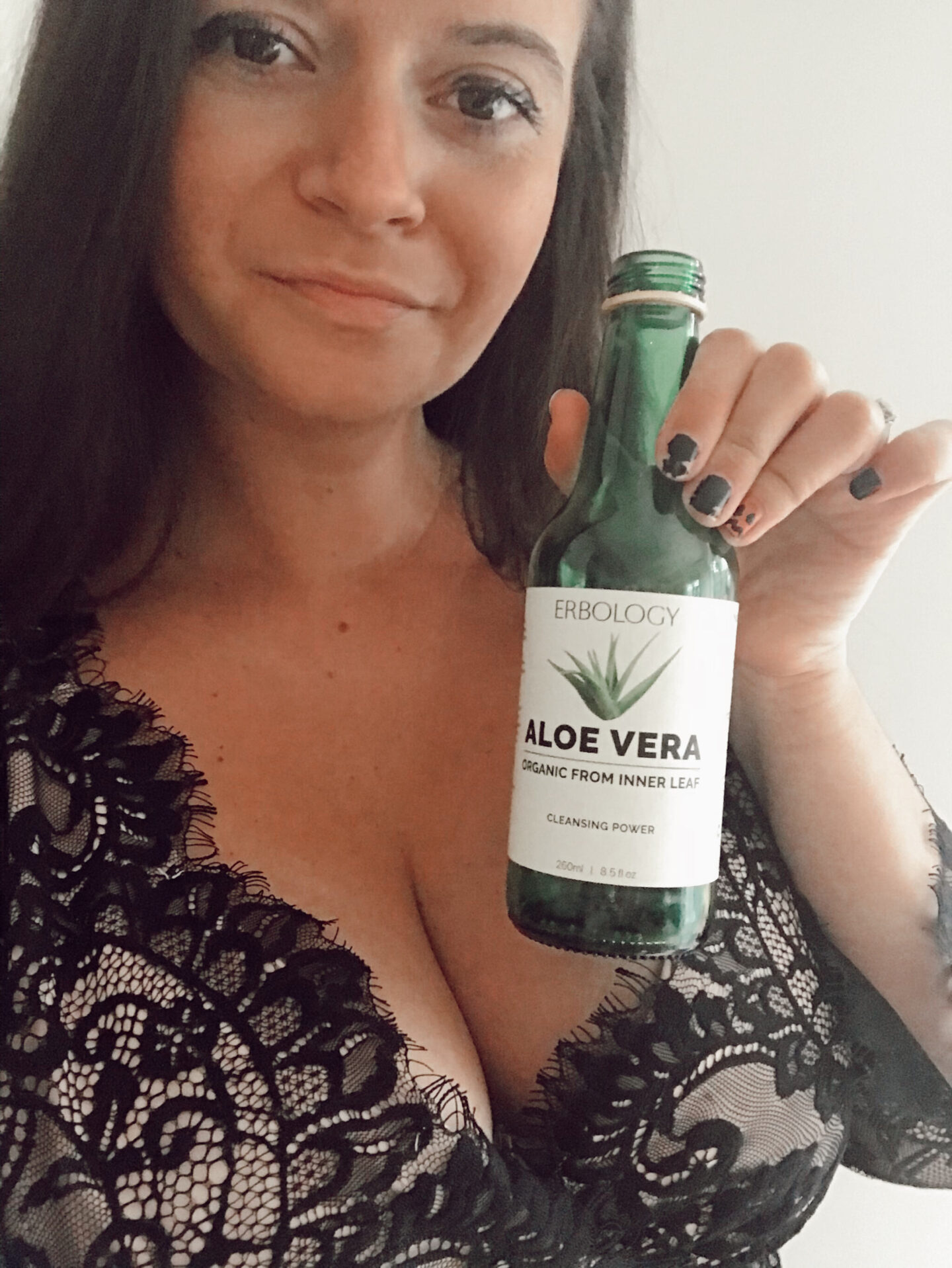 a female poses with a bottled drink